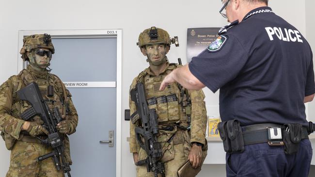 Australian Army soldier Corporal Ben Dauncey and Army officer Lieutenant William Proudford from 3rd Battalion Royal Australian Regiment Charlie Company liaise with Bowen Police Senior Sergeant Craig Shepherd. Picture: Supplied