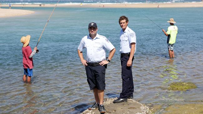 DPI Fisheries officers Ben Travis (left) and Jai Settree at The Entrance waterfront. Fisheries are cracking down on people catching undersized fish. Picture: Mark Scott