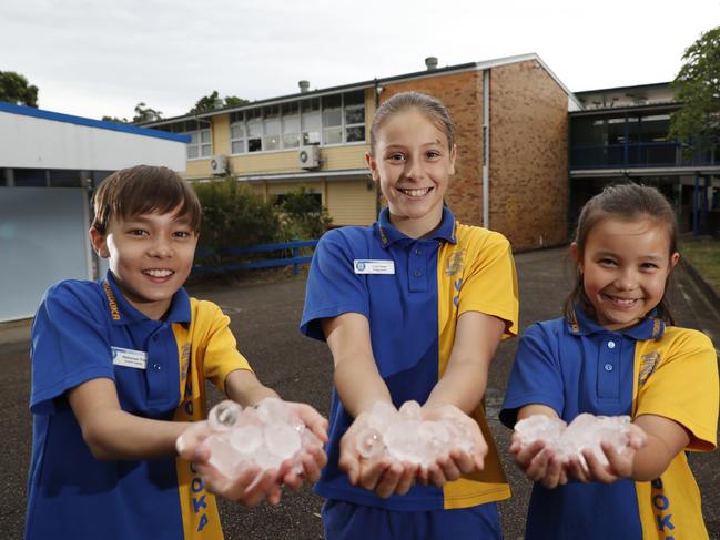 File picture: Nathanael Tran, Livia Fischer, School captain and Jess Tran celebrate playing with ice as Moorooka State School got half its class rooms air conditioned in November, 2018. File picture: AAP/Regi Varghese