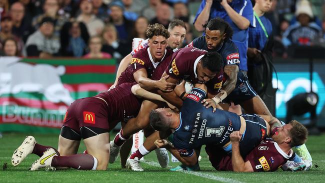 James Tedesco of the Blues is held up over the try line during Game 1. (Photo by Mark Kolbe/Getty Images)