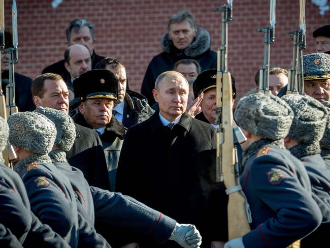 (From 2ndL) Russian Prime Minister Dmitry Medvedev, Russian President Vladimir Putin and Defence Minister Sergey Shoygu attend a wreath laying ceremony at the Tomb of the Unknown Soldier near the Kremlin wall to mark Defender of the Fatherland Day in Moscow on February 23, 2018.  Defender of the Fatherland Day, celebrated in Russia on February 23, honours the nation's army and is a nationwide holiday.  / AFP PHOTO / Yuri KADOBNOV