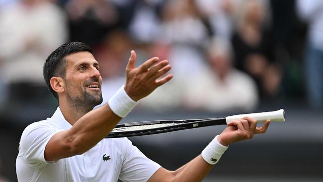 Serbia's Novak Djokovic imitates playing the violin with his racquet as he celebrates winning against Italy's Lorenzo Musetti. (Photo by ANDREJ ISAKOVIC / AFP) / RESTRICTED TO EDITORIAL USE