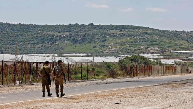 Israeli soldiers patrol along the road by the security fence near Ibthan, in central Israel, separating it from the occupied West Bank on April 13. After a recent wave of attacks in Israel, the military has focused its response on the restive Jenin Palestinian refugee camp in the north of the occupied West Bank.