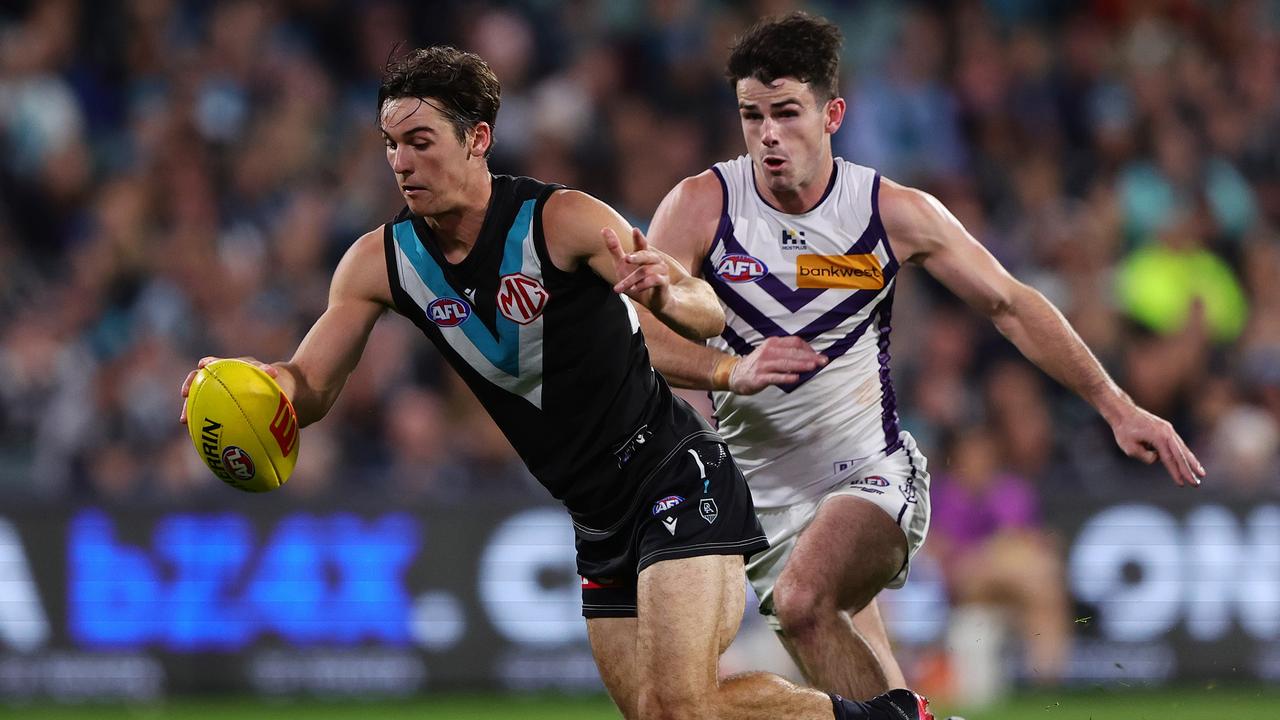 ADELAIDE, AUSTRALIA - APRIL 13: Connor Rozee of the Power and Andrew Brayshaw of the Dockers during the 2024 AFL Round 05 match between the Port Adelaide Power and the Fremantle Dockers at Adelaide Oval on April 13, 2024 in Adelaide, Australia. (Photo by Sarah Reed/AFL Photos via Getty Images)