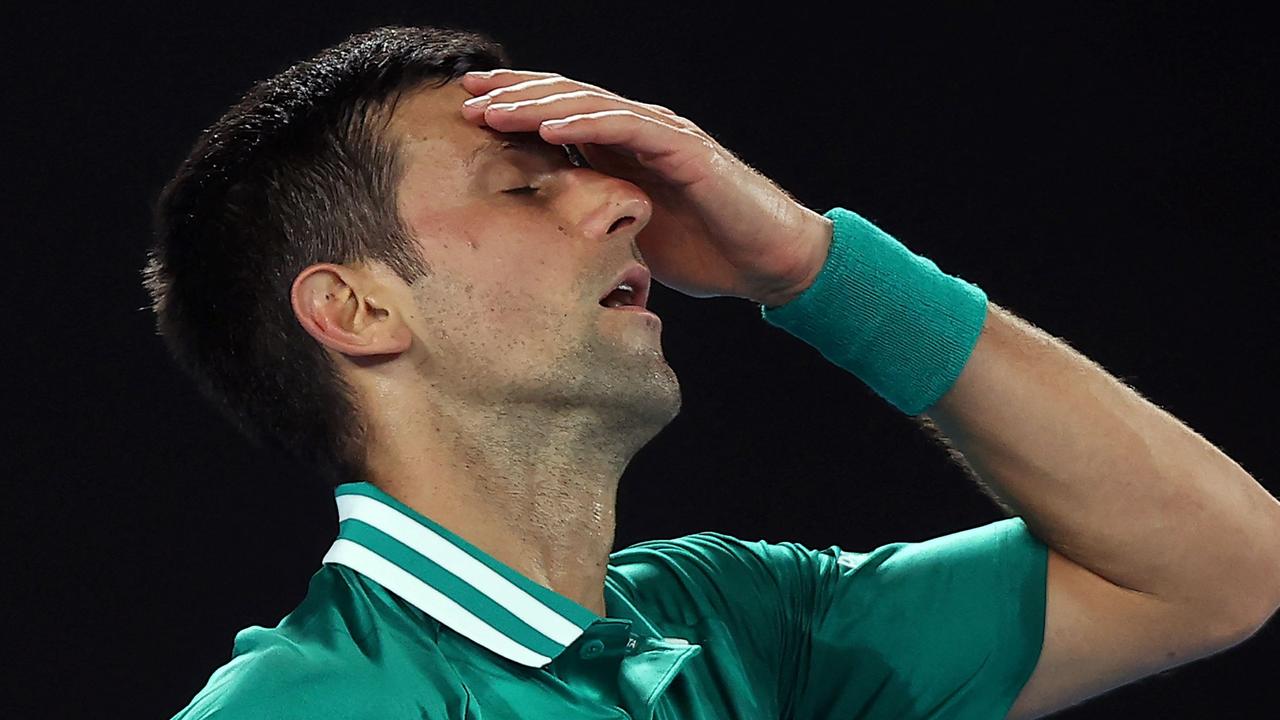 (FILES) This file photo taken on February 16, 2021 shows Serbia's Novak Djokovic reacting after losing a point against Germany's Alexander Zverev during their men's singles quarter-final match on day nine of the Australian Open tennis tournament in Melbourne. – Australia's government cancelled Novak Djokovic's visa for a second time on January 14, 2022 as it sought to deport the superstar over his Covid-19 vaccine status. (Photo by Brandon MALONE / AFP) / — IMAGE RESTRICTED TO EDITORIAL USE – STRICTLY NO COMMERCIAL USE —