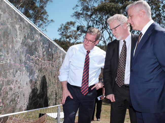 Member for Groom Dr John McVeigh, ARTC Inland Rail Program CEO Richard Wankmuller, and federal Infrastructure Minister Michael McCormack inspect Inland Rail plans.