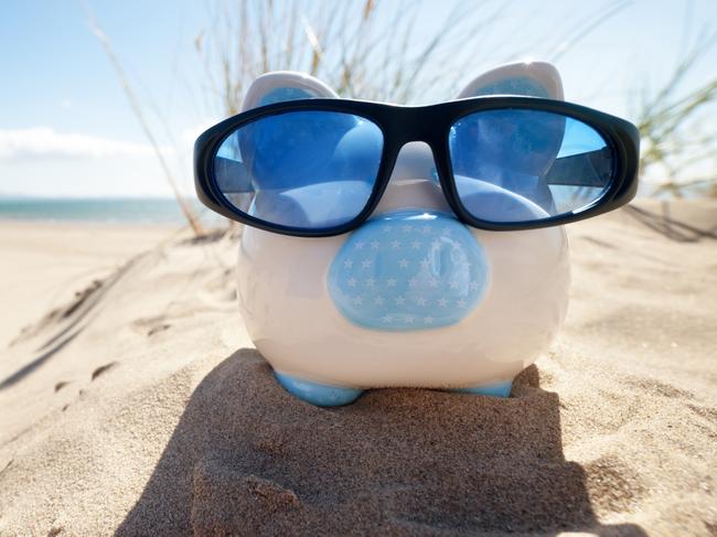 Holiday savings piggy bank on a beach vacation with sunglasses, sunshine generic