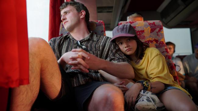 Sophie (Frankie Corio) rests her head against Calum’s (Paul Mescal’s) shoulder as they travel by bus in Aftersun