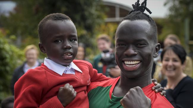 Awer Mabil, Socceroos player who scored the final goal to get Australia into the world cup, is visiting his former school, with student Ajak Atem. Picture: Roy VanDerVegt