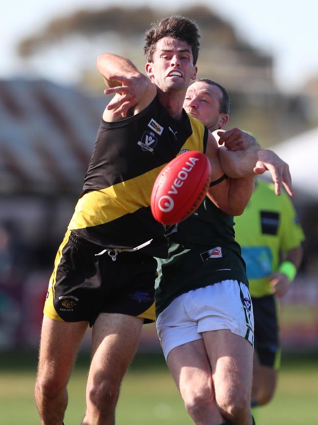 Rochester’s Lachlan Watson leads Echuca’s Kane Morris to the ball. Pictures: Yuri Kouzmin