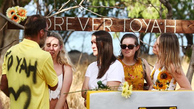 A large, permanent concrete memorial for Toyah Cordingley has been unveiled in a service at Wangetti Beach. Family friend Wayne "Prong" Trimble comforts Toyah's friends Megan Amour, Jade Atfield, Rebekah Moore and Rebekah Batty after the memorial. PICTURE: BRENDAN RADKE