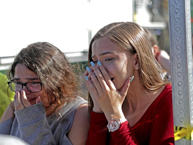 Students are overcome with emotion following the shooting at Marjory Stoneman Douglas High School. Picture: AP