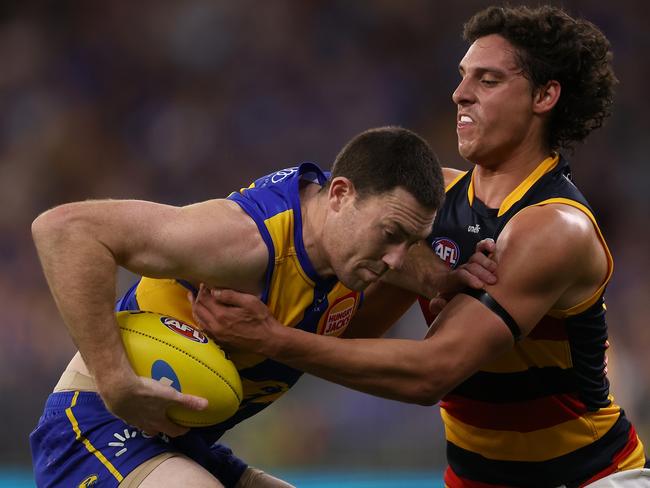 PERTH, AUSTRALIA - AUGUST 26: James Borlase of the Crows tackles Jeremy McGovern of the Eagles during the round 24 AFL match between the West Coast Eagles and Adelaide Crows at Optus Stadium, on August 26, 2023, in Perth, Australia. (Photo by Paul Kane/Getty Images)