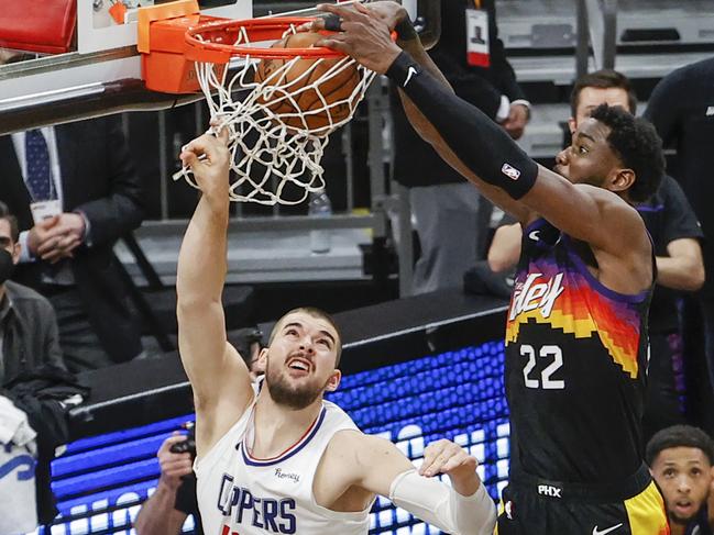 PHOENIX, ARIZONA - JUNE 22: Deandre Ayton #22 of the Phoenix Suns dunks the ball over Ivica Zubac #40 of the LA Clippers  during the fourth quarter in game two of the NBA Western Conference finals in-which the Phoenix Suns defeated the LA Clippers 104-103 at Phoenix Suns Arena on June 22, 2021 in Phoenix, Arizona. NOTE TO USER: User expressly acknowledges and agrees that, by downloading and or using this photograph, User is consenting to the terms and conditions of the Getty Images License Agreement.  (Photo by Christian Petersen/Getty Images)