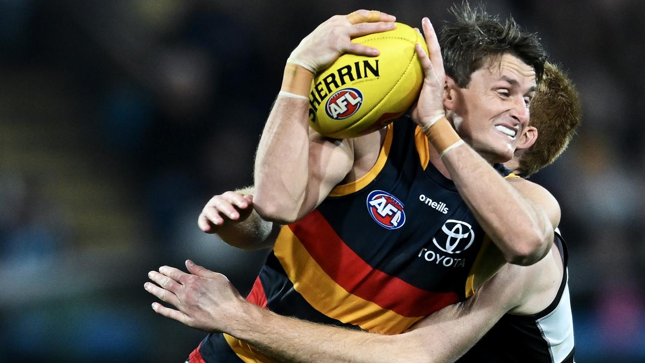 Matt Crouch of the Crows is tackled by Willem Drew of Port Adelaide. Picture: Mark Brake/Getty Images
