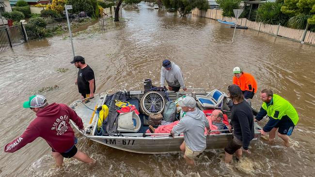 Kate Pianta, her husband Ray and their dog Grace being rescued in Rochester. Picture: Jason Edwards