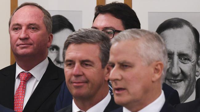 Former Nationals leader Barnaby Joyce (left) stands behind Nationals party leader Michael McCormack, right, after he took over the job in February.