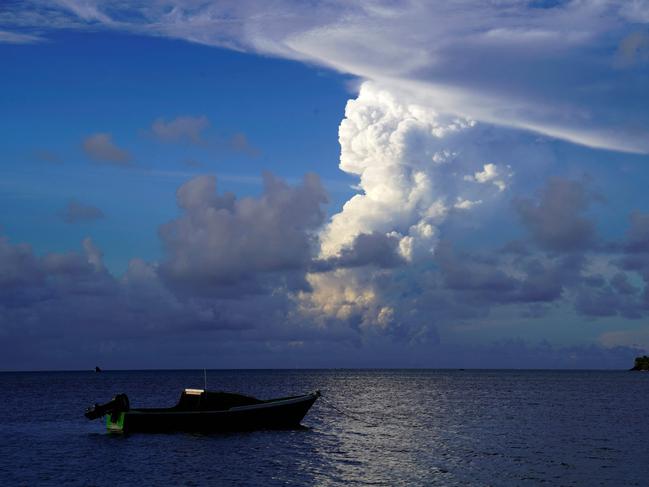 (FILES) This file photo taken on December 21, 2021 shows white gaseous clouds rising from the Hunga Ha'apai eruption seen from the Patangata coastline near Tongan capital Nuku'alofa. - Frightened Tongans fled to higher ground on January 15, 2022 after the latest eruption of the Hunga Tonga-Hunga Ha'apai volcano -- heard in neighbouring countries -- triggered tsunami warnings across the South Pacific. (Photo by Mary Lyn FONUA / AFP)