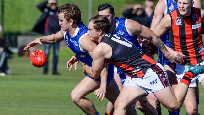 SPOC’s Lachlan De Cesare under pressure against Rostrevor Old Collegians on Saturday. Picture: Brenton Edwards