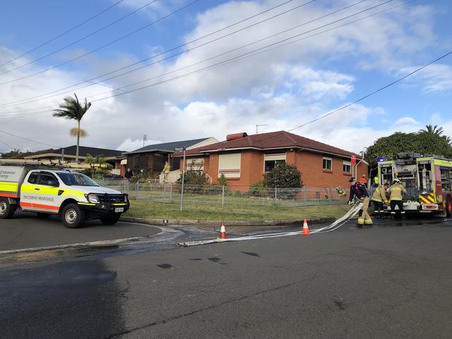 Emergency services out the front of the burning home.