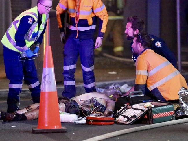 Paramedics treat the man for severe burns and cuts before he was taken to hospital in a critical condition.