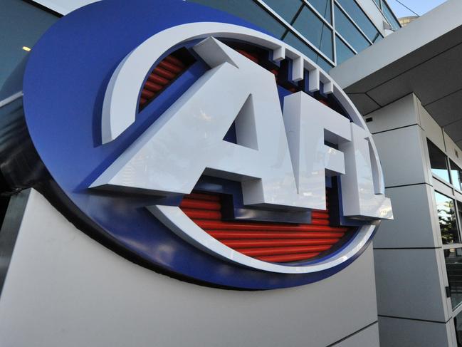 A man arrives at AFL House in Melbourne, Tuesday, Aug. 13, 2013. (AAP Image/Julian Smith) NO ARCHIVING