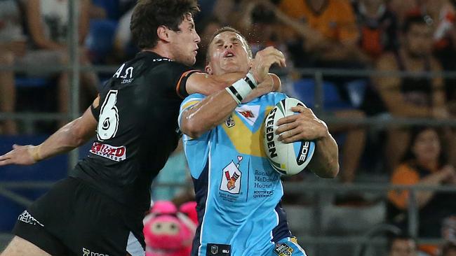 William Zillman (right) of Gold Coast Titans is tackled by Mitchell Moses.