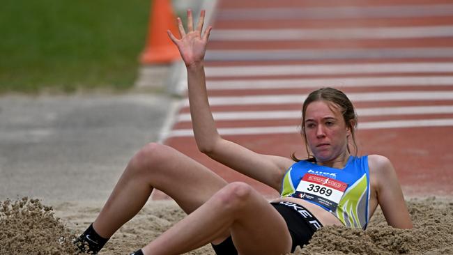 Hailey Buckley lands hard in the triple jump. Picture: Andy Brownbill