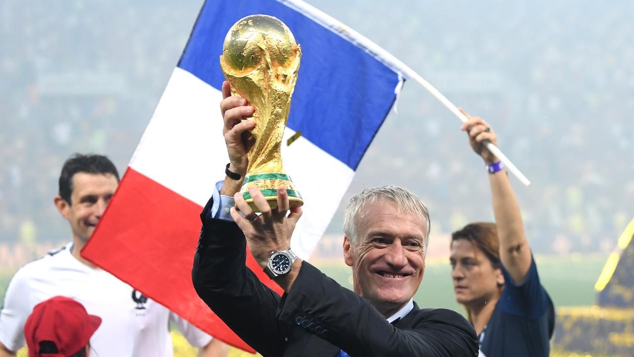 Didier Deschamps celebrates with the World Cup trophy.