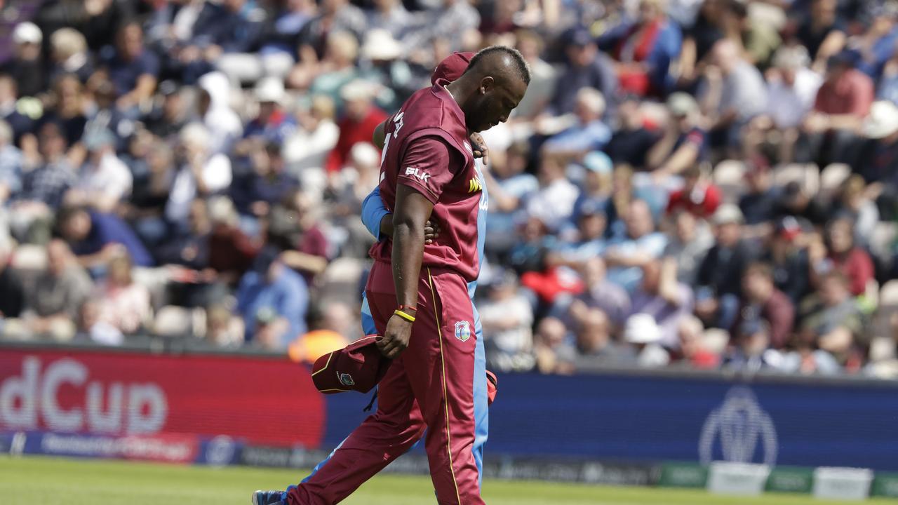 Andre Russell leaves the field after injury. Photo: Matt Dunham/AP Photo.