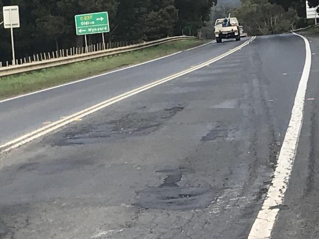 Traffic passes potholes on the Bass Highway near Wynyard