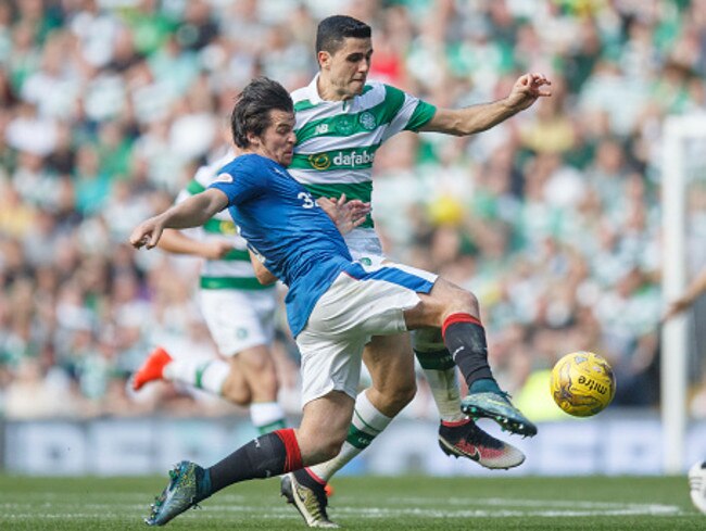 Joey Barton of Rangers (L) challenges Tom Rogic of Celtic.