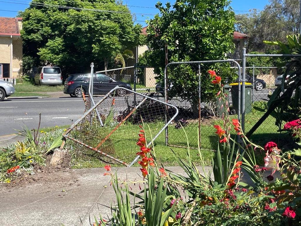 A neighbour's fence was damaged on Monday when men linked to the home invasion crashed a car and threw a gun into bushes.