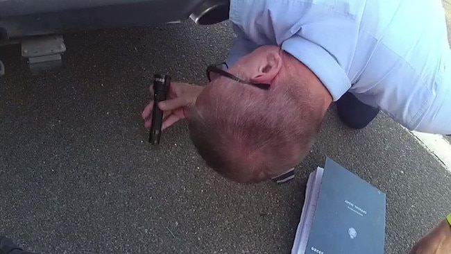 A police officer looks underneath the car. Picture: supplied