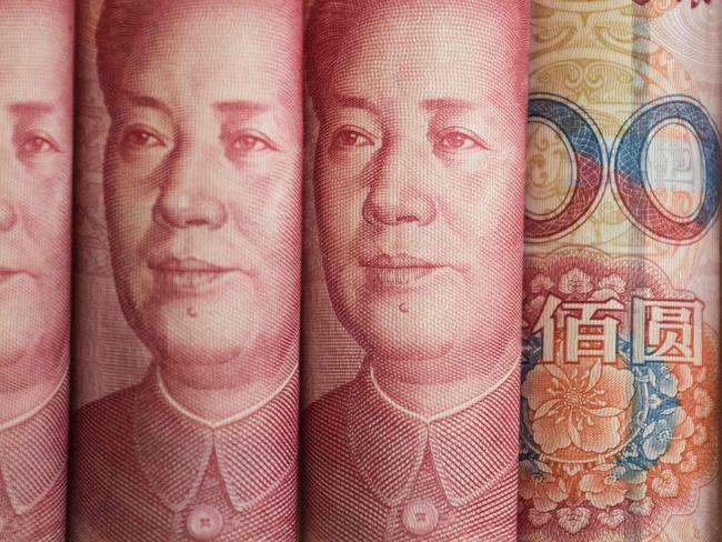 This photo illustration taken on January 6, 2017 shows Chinese 100 yuan notes in Beijing. China just raised the exchange rate for the yuan against the US dollar by 0.92 percent from the previous day, the biggest one-day increase in more than 11 years. / AFP PHOTO / FRED DUFOUR