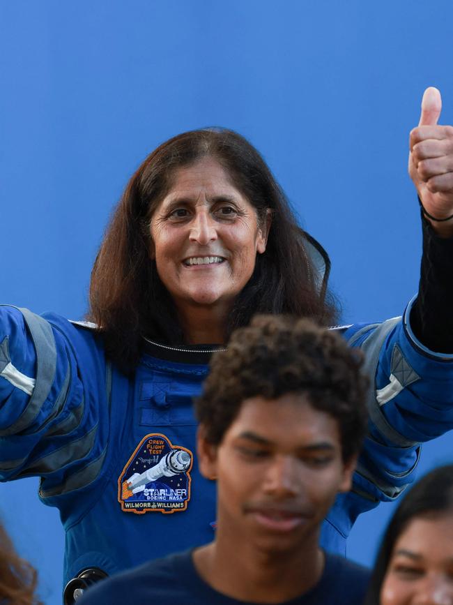 Suni Williams salutes the crowd as she walks out of the operations Building on June 5. Picture: AFP