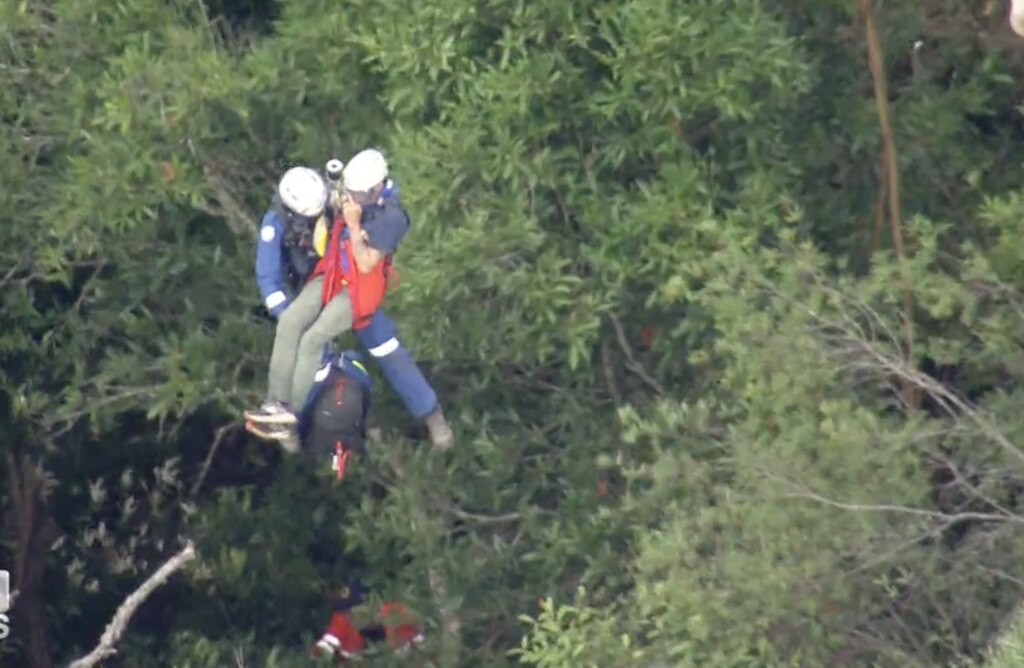 He was winched from the rocky area before being taken to hospital in an ambulance. Picture: 9 News