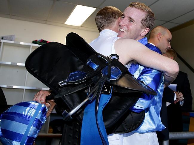 Nathan is swamped with a huge hug from twin brother Tommy in the jockeys room after his big win. Picture: Adam Head