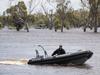 Police boats search flooded lagoon after body found