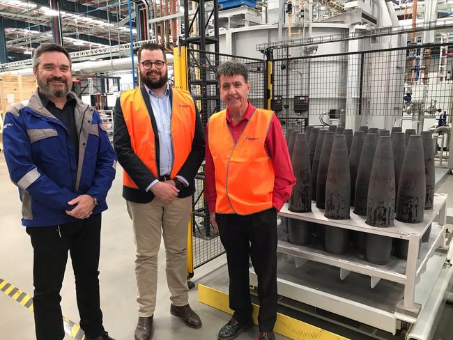 (From left) Rheinmetall NIOA Munitions project manager Jeff Crabtree, RNM director Jackson Nioa and Maryborough MP Bruce Saunders with the first projectiles to come out of the $60m shell forging plant at Maryborough.