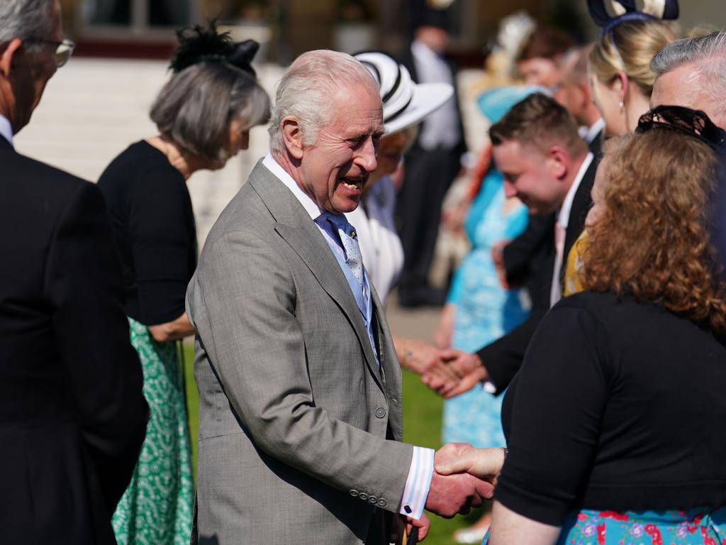 Just a few kilometres away, Kng Charles mingled with garden party guests at Buckingham Palace. Picture: Getty Images