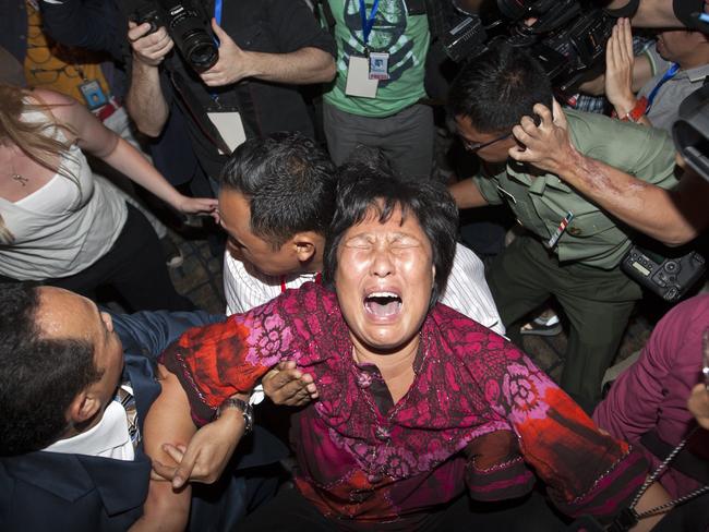 A family member of missing relative on MH370 breaks down as she speaks to the media at Kuala Lumpur International Airport. Picture: EPA