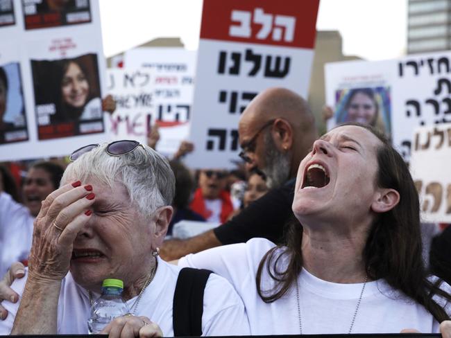 A woman weeps and another shouts as family and friends of hostages taken from Kfar Aza demonstrate in Tel Aviv museum plaza, Israel. Families of the victims worry that the military offensive may result in hostages being killed. Picture: Getty Images