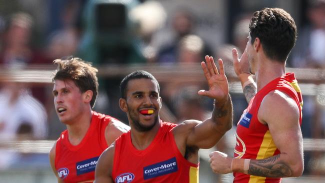 Touk Miller of the Suns celebrates a goal with team mate Alex Sexton during the 2020 Marsh Community Series match between the Adelaide Crows and the Gold Coast Suns at Flinders University Stadium on March 06, 2020 in Adelaide, Australia. (Photo by AFL Photos)