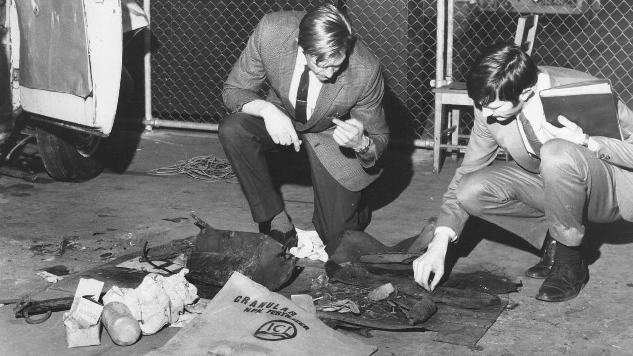 Police examine the contents of the car after it was removed from the gorge.