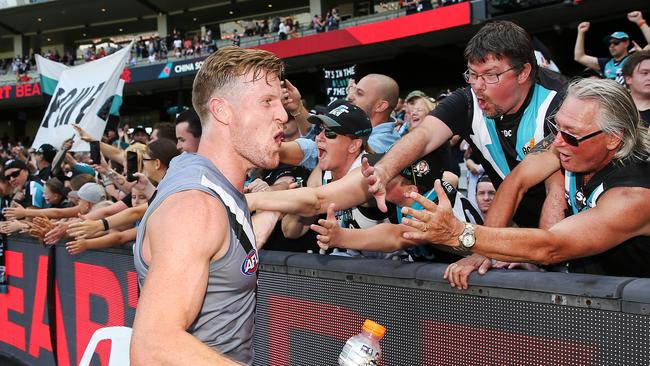 Tom Jonas celebrates his first official win as Port Adelaide co-captain with fans at the MCG. Picture: Michael Dodge/Getty Images