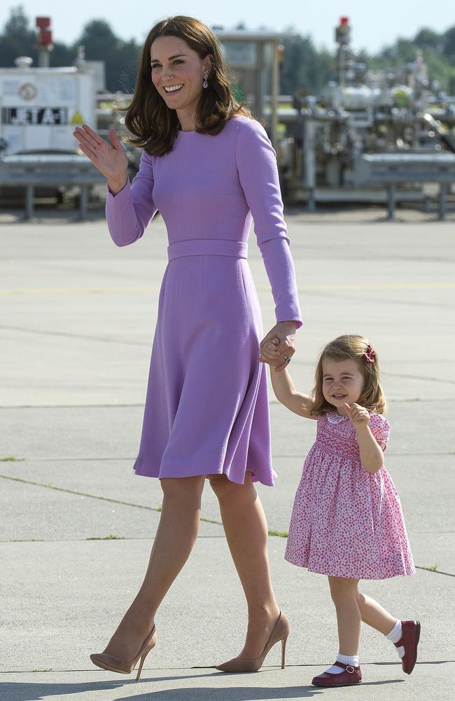 Ladies in purple. Kate’s Emilia Wickstead frock was of a similar sartorial tone to her daughter’s floral-printed dress. Picture: AP