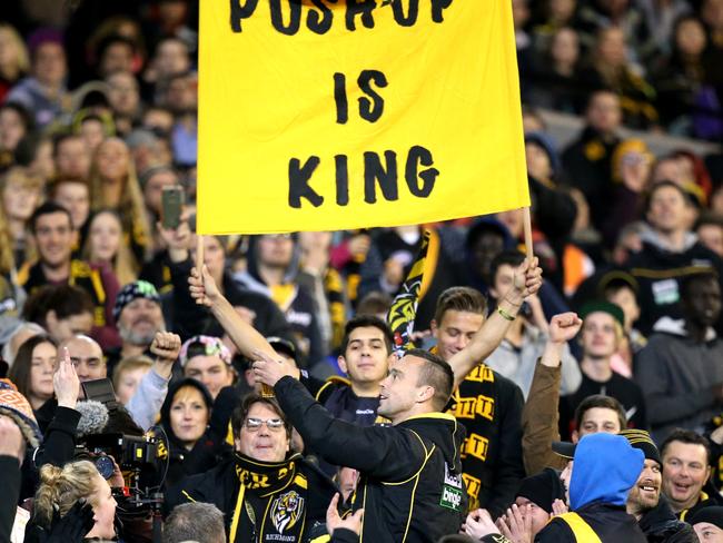 Jake King has a beer with the Richmond cheer squad during a Tigers match in 2014. Picture: Tim Carrafa