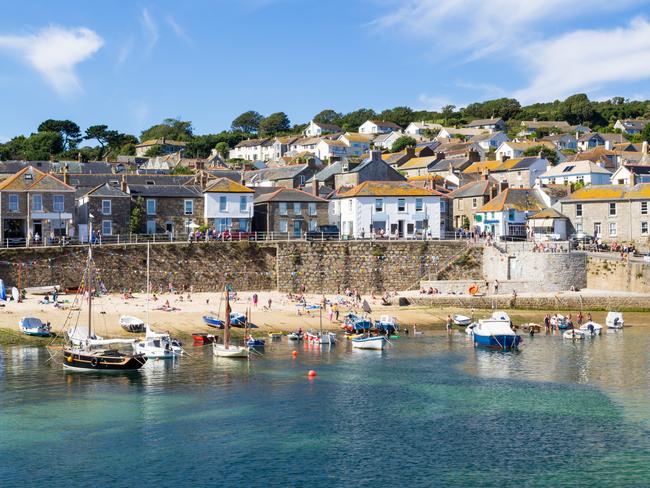 Summer at the historic fishing harbour Mousehole Cornwall England UK EuropeT&L food