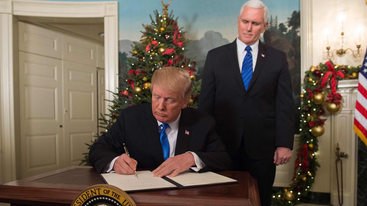 If Donald Trump resigns, Vice President Mike Pence (right) could pardon the President and members of his family. Picture: Saul Loeb/AFP